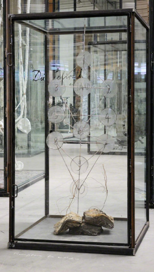 Anselm Kiefer, Die Sefiroth, 2010, Burned books, wire, steel and numbered and inscribed glass discs in inscribed glass and steel vitrine, 231 x 130,2 x 130,2 cm