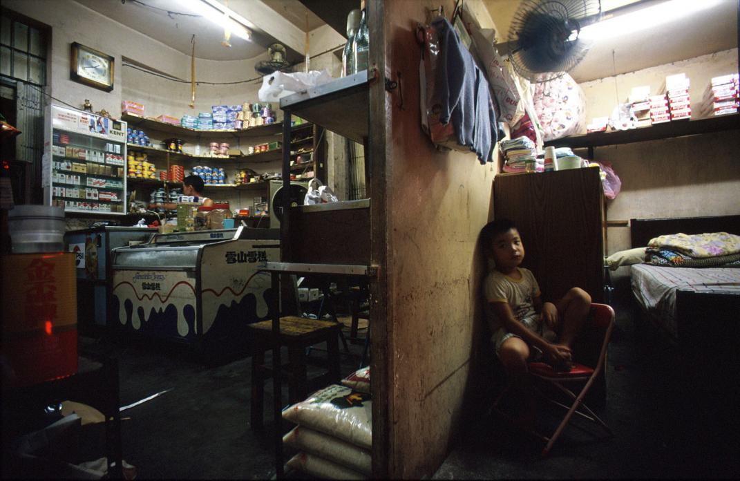 Young boy in living area in back of family shop, 1990