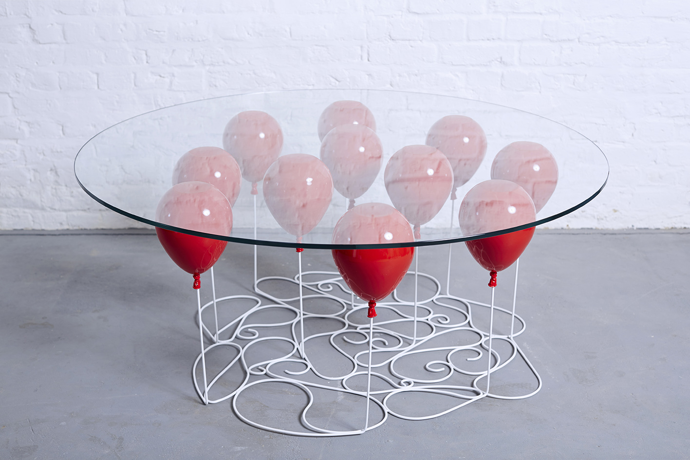A Coffee Table Made Out Of Glass Based On 11 Helium Balloons Art