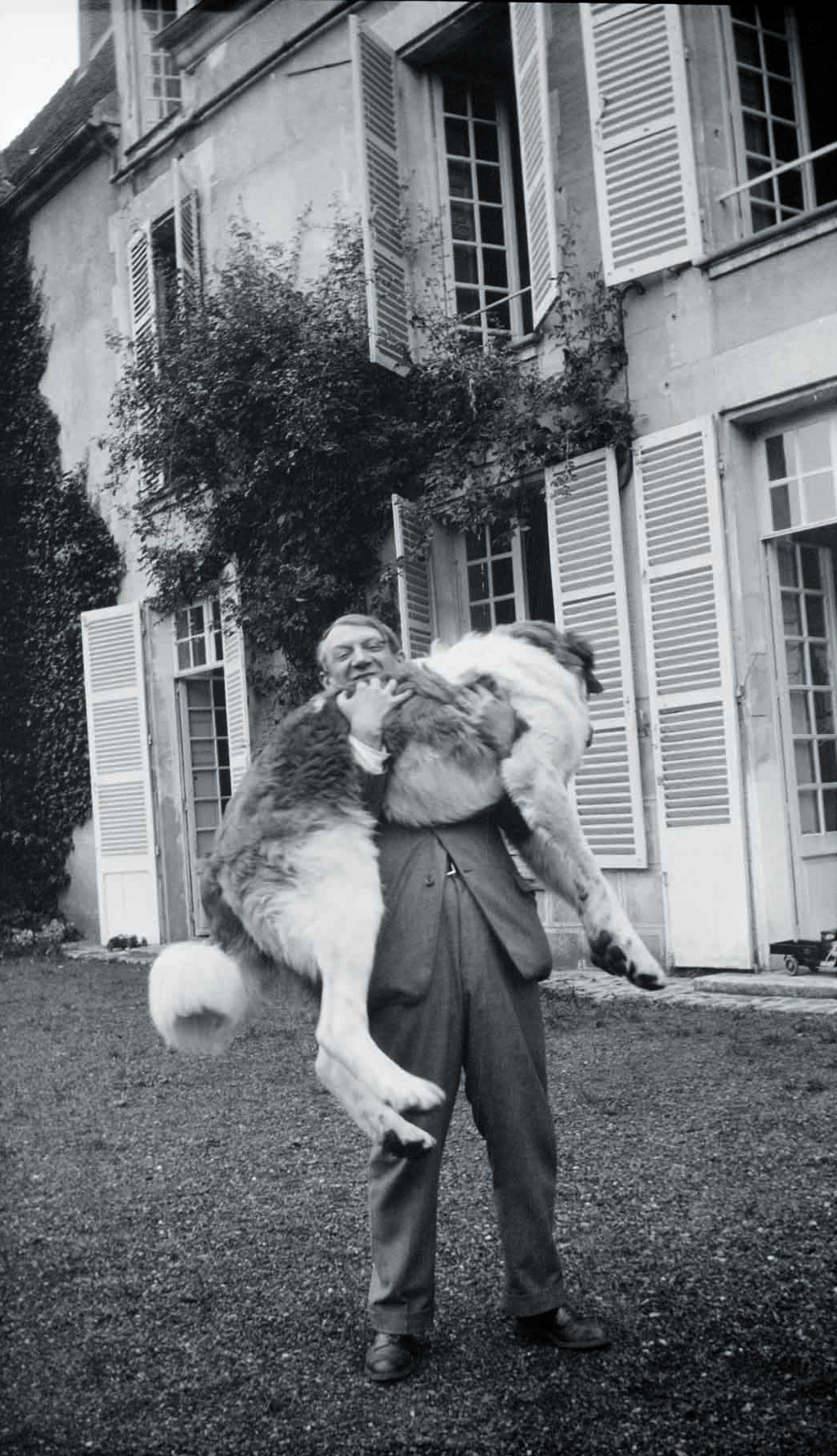 Picasso with Bob (the Great Pyrenees), shot at Château de Boisgeloup, France, 1932. 