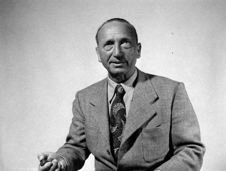 Director Michael Curtiz holding shutter release as he takes his own photograph.
