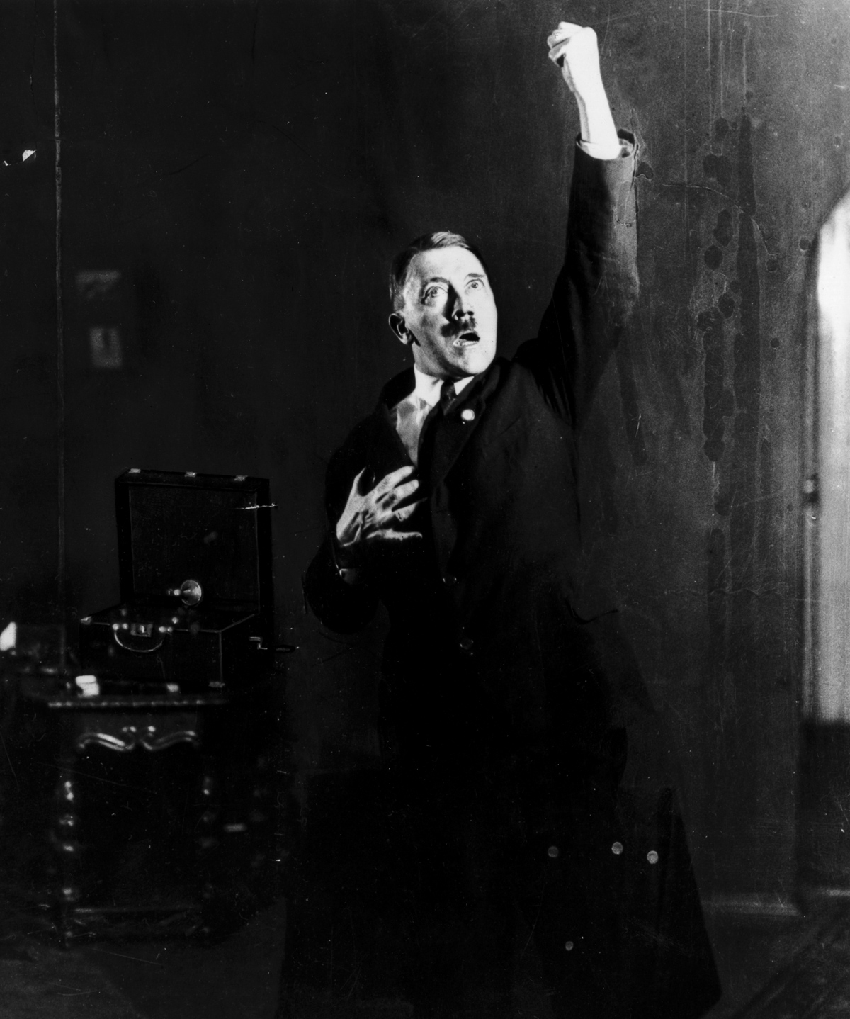 Adolf Hitler (1889 - 1945), leader of the National Socialist German Workers' Party (NSDAP), strikes a pose for photographer Heinrich Hoffmann whilst listening to a recording of his own speeches. After seeing the photographs, Hitler ordered Hoffmann to destroy the negatives, but he disobeyed. (Photo by Heinrich Hoffmann/Getty Images)