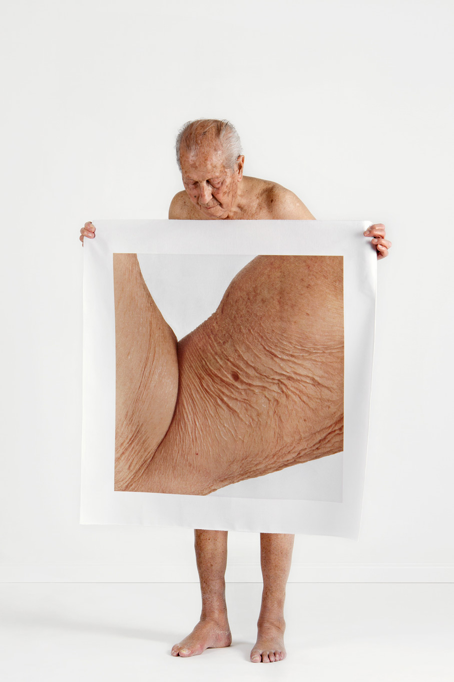 Nude Portraits Of People Holding Pictures Of Enlarged Body Parts