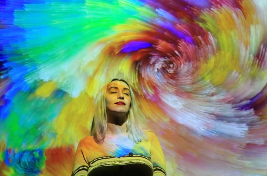 Alt text: A woman standing in front of a colorful background